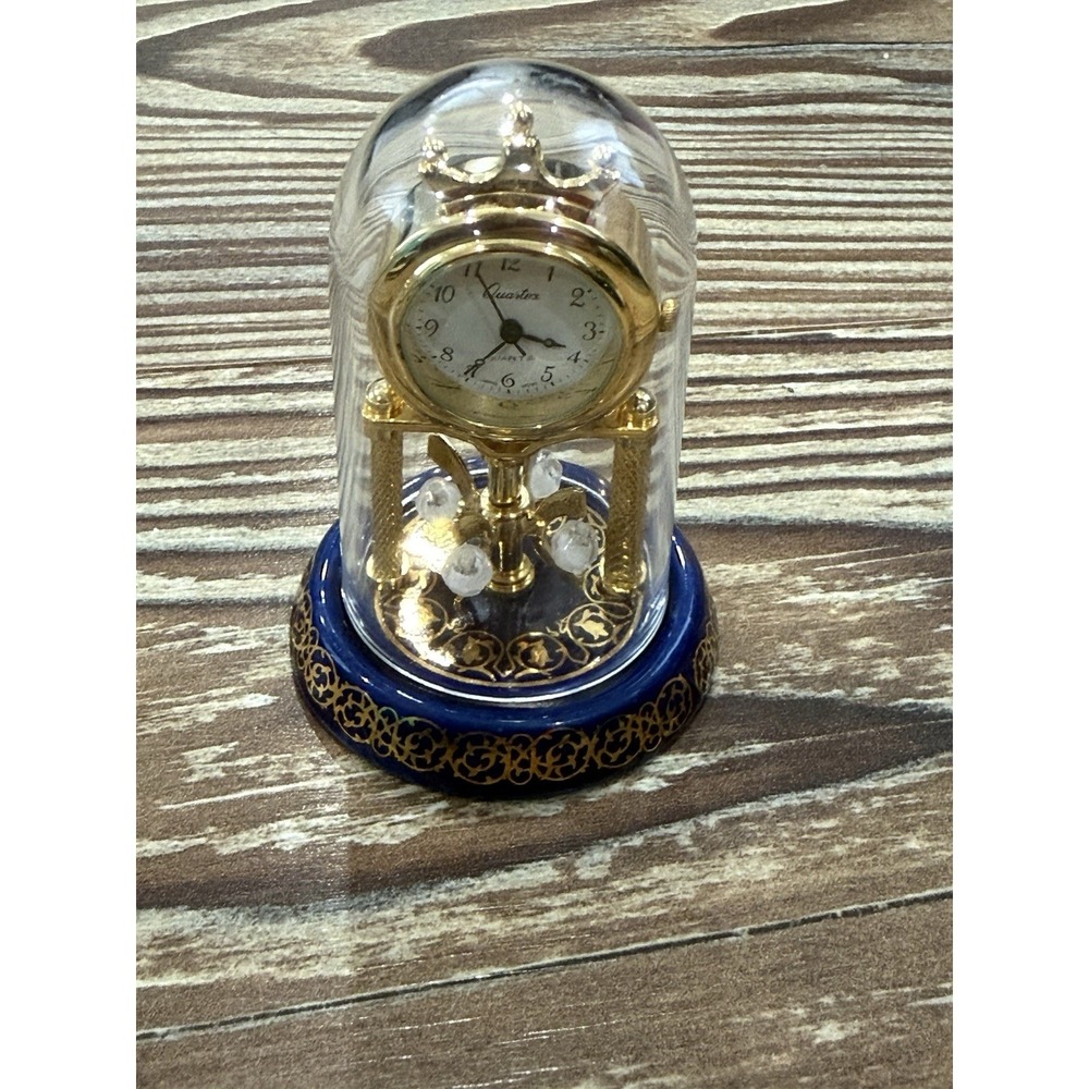 Quartex Quartz Anniversary Torsion Desk Clock Gold Tone Blue Base Clear Dome